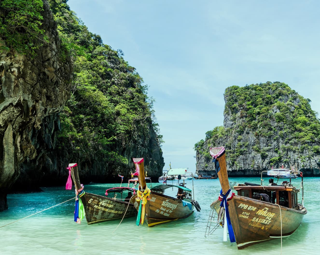 tourist boats moored at a tropical beach in Thailand