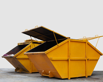 Ready mixed cement being poured into a trench with a spade being used to level the cement.