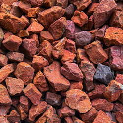 A close up photograph of red coloured agregate.