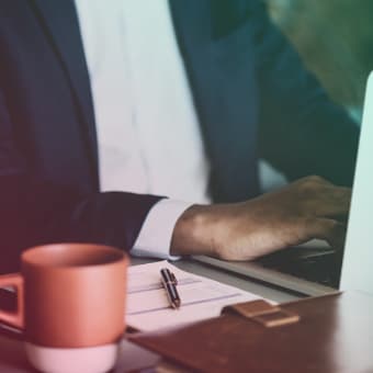 A Financial Director typing on his laptop at his desk