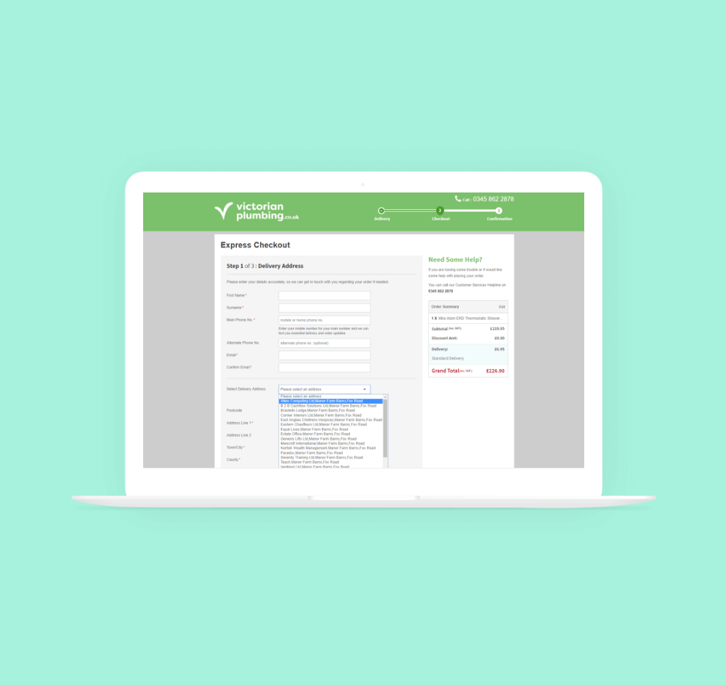An example of Victorian Plumbing's checkout page displayed on a laptop sat on a green background.